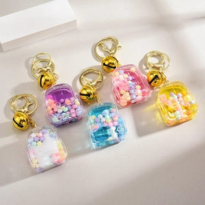 Porte-clés mini sac à dos en acrylique avec sable mouvant et cloches dorées en six couleurs