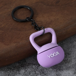 Detail shot of a mini purple kettlebell keychain with white Yoga lettering and black metal ring