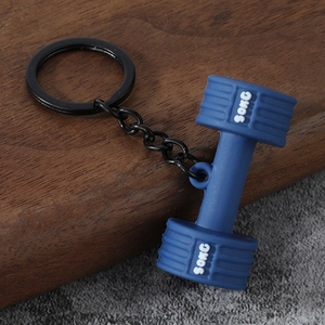 Close-up of blue silicone dumbbell keychain with 50KG engraving on wood surface