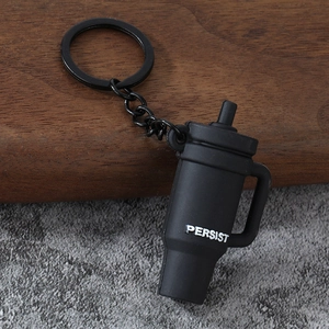 Detailed view of mini matte black protein shaker keychain with PERSIST lettering