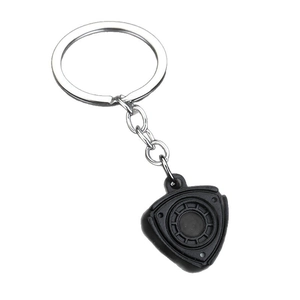 Creative black matte rotary engine rotor keychain with silver ring on white background