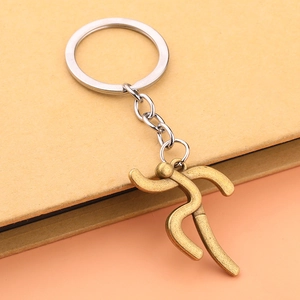 Detail of a vintage bronze running figure keychain with durable stainless steel ring