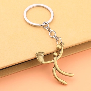 Detailed view of a bronze shouting person figurine keychain with silver chain and keyring