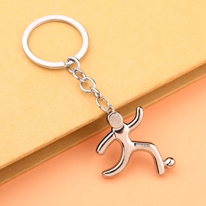 Detailed close-up of a silver zinc alloy keychain featuring a soccer player silhouette