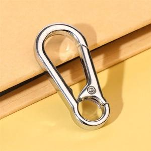 Close-up of a high-polish D-shaped metal carabiner keychain with a spring-gate closure