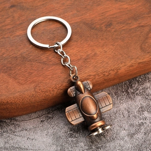 Vintage bronze-style biplane model keychain with rustic metal finish and silver ring