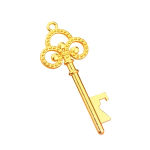 Vintage golden key bottle opener with ornate floral design for wedding party favors