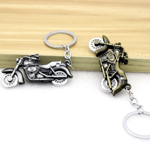 Retro motorcycle keychain pendant with movable wheels in antique silver and bronze finishes