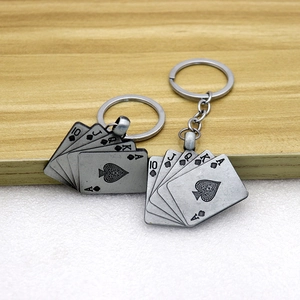 Vintage royal flush spade poker card keychain with retro gray alloy finish on wood surface