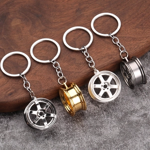 Set of four metal car rim keychains in chrome, gold, silver, and gunmetal finishes