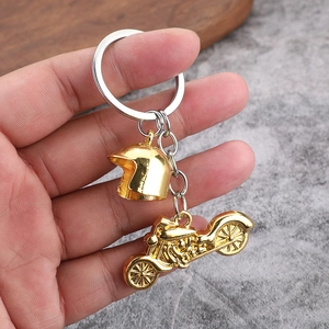 Golden motorcycle helmet metal keychain pendant on silver ring with vintage styling