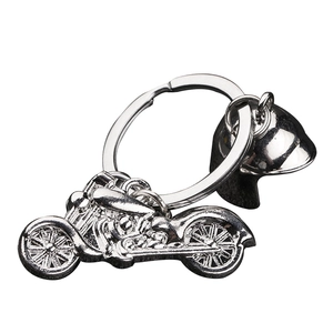 Polished silver motorcycle and helmet keychain set on a clean white background