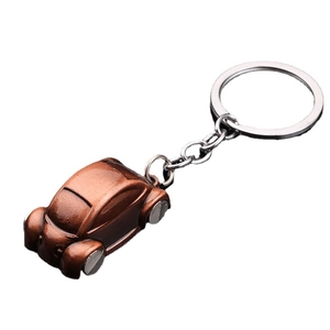 Vintage bronze beetle car keychain made of zinc alloy on a white background