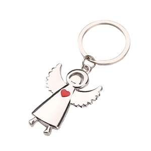 Silver metal angel wings keychain with red heart accent on a clean white background