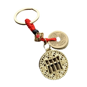 Traditional Chinese abacus keychain with copper coins and red braided cord on white background