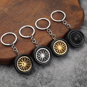 Set of four creative PVC rubber tire keychains with gold and silver alloy sport rims
