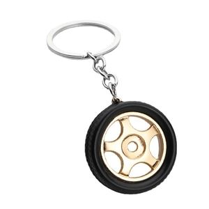 3D miniature car wheel hub keychain with black tire and golden 5-spoke metal rim