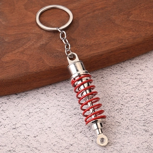 Realistic silver and red shock absorber keychain accessory for car enthusiasts