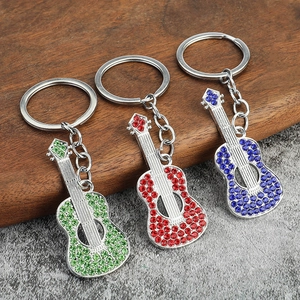 Set of three colorful rhinestone guitar keychains in red, green, and blue metal finish