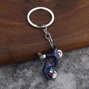Blue retro scooter keychain with ROMA text and Italian flag on a dark wood background