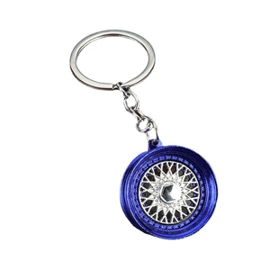 Blue BBS style alloy car wheel rim keychain with silver spokes on white background