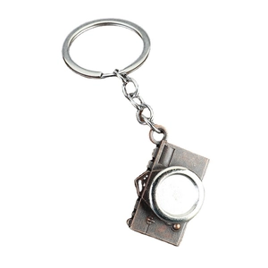 Vintage bronze alloy camera keychain with detailed miniature lens and secure metal ring