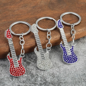 Sparkling crystal electric guitar keychains in red, silver, and blue finishes