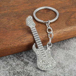 Detailed view of silver electric guitar keychain with sparkling pave rhinestones
