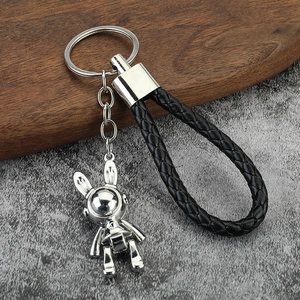 Space rabbit metal keychain with silver astronaut pendant and black braided leather strap