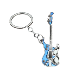 Metal guitar keychain with blue enamel inlay and sparkling rhinestones on white backdrop