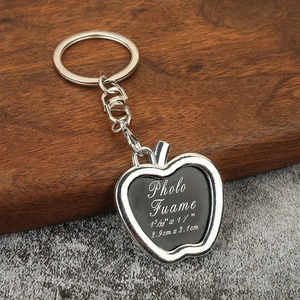 Polished silver apple-shaped photo frame keychain with lobster clasp and ring
