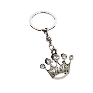 Silver crown keychain with sparkling rhinestones and metal ring on white background