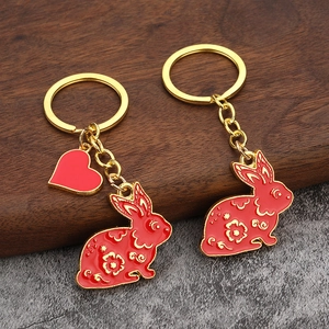 Cute rabbit keychain charms with red enamel and gold flower patterns for bag accessories