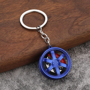 Blue six-spoke car wheel rim keychain with red brake caliper and metal ring chain