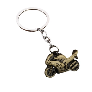 Vintage bronze motorcycle keychain with detailed engine design on a white background