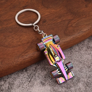 Rainbow plated metal F1 racing car keychain with a polished iridescent finish on wood