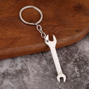 Macro detail of silver metal wrench keychain with realistic hardware tool texture