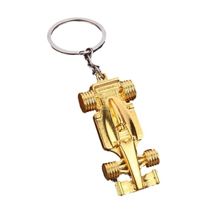 Polished golden F1 race car keychain made of metal alloy with detailed tires and wing