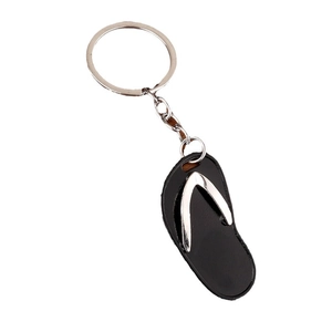 Creative flip flop keychain with black sole and silver metal strap on white background