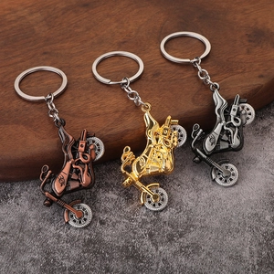 Three vintage motorcycle alloy keychains in bronze, gold and silver metal finishes
