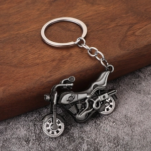 Retro silver alloy motorcycle keychain with vintage finish and detailed engine design