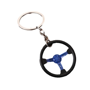 Racing steering wheel keychain with black matte rim and blue three-spoke metal center
