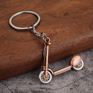 Vintage bronze metal keychain featuring a highly detailed miniature scooter pendant and ring