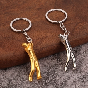Creative golf player keychains in gold and silver zinc alloy finish on a wooden background