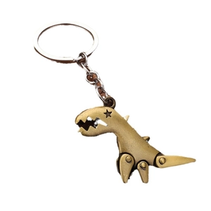 Retro mechanical metal dinosaur keychain with movable limbs and star cutout on white background
