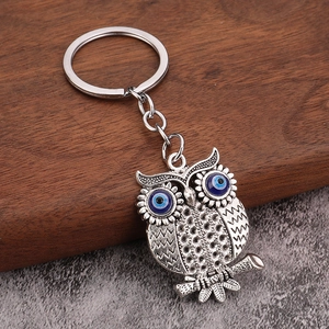 Detailed view of owl evil eye keychain with blue beads and vintage silver finish