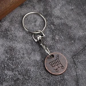 Close-up of bronze metal shopping trolley token with swivel lobster clasp and keychain