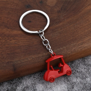 Detailed close-up of a red 3D mini golf cart keychain with silver metal ring and chain