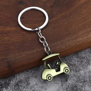 Macro detail of a vintage bronze golf cart keychain with realistic 3D zinc alloy texture