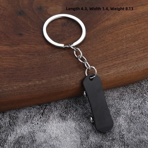Detailed close-up of mini black skateboard keychain with silver metal ring and dimensions